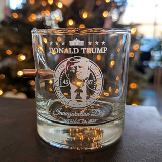 Clear whiskey glass featuring Donald Trump's inauguration details, including the presidential seal and date, set against a...