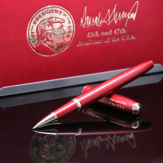 Red executive order pen with silver accents, featuring Donald Trump's signature and "45th and 47th President of the U.S.A.