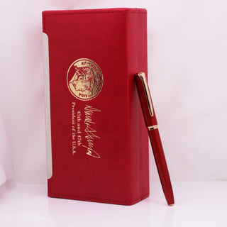 President Trump 2nd term executive order pen in a red case with gold embossed seal and signature.