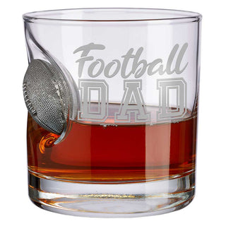 BenShot "Football Dad" glass featuring a football-shaped design and engraved text, filled with a brown liquid.