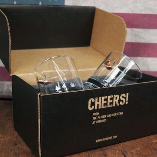 BenShot gift set featuring two glass whiskey tumblers in a black box with "Cheers!" text and copper accents.