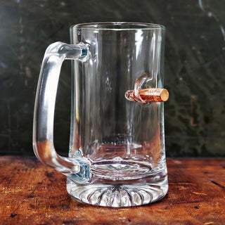 BenShot MugShot beer mug, 24oz, clear glass with a copper bullet embedded in the side, featuring a sturdy handle.