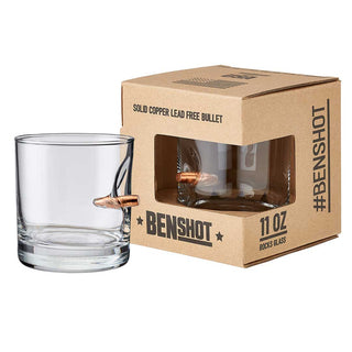 BenShot 11oz rocks glass with a solid copper bullet embedded, displayed next to its kraft box packaging.