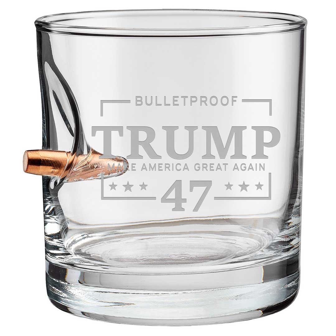 Clear whiskey glass with a bullet design, engraved "Bulletproof Trump 47" and stars on the front.