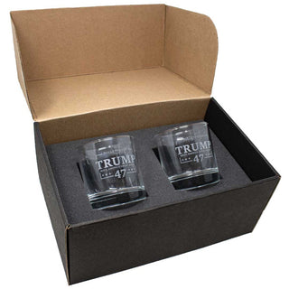 Two Bulletproof Trump 47 whiskey glasses displayed in a black gift box with a foam insert.