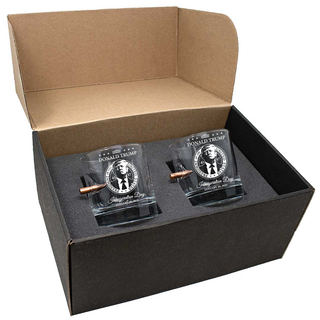 Bulletproof Trump inauguration whiskey glass set in a black gift box with foam padding, featuring engraved designs.