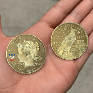 America's 250th Anniversary Peace Dollar golden proof coin held in a hand, featuring Liberty and an eagle design.