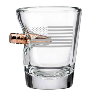 US flag shot glass with a bullet design, featuring a clear glass body and engraved flag detail.